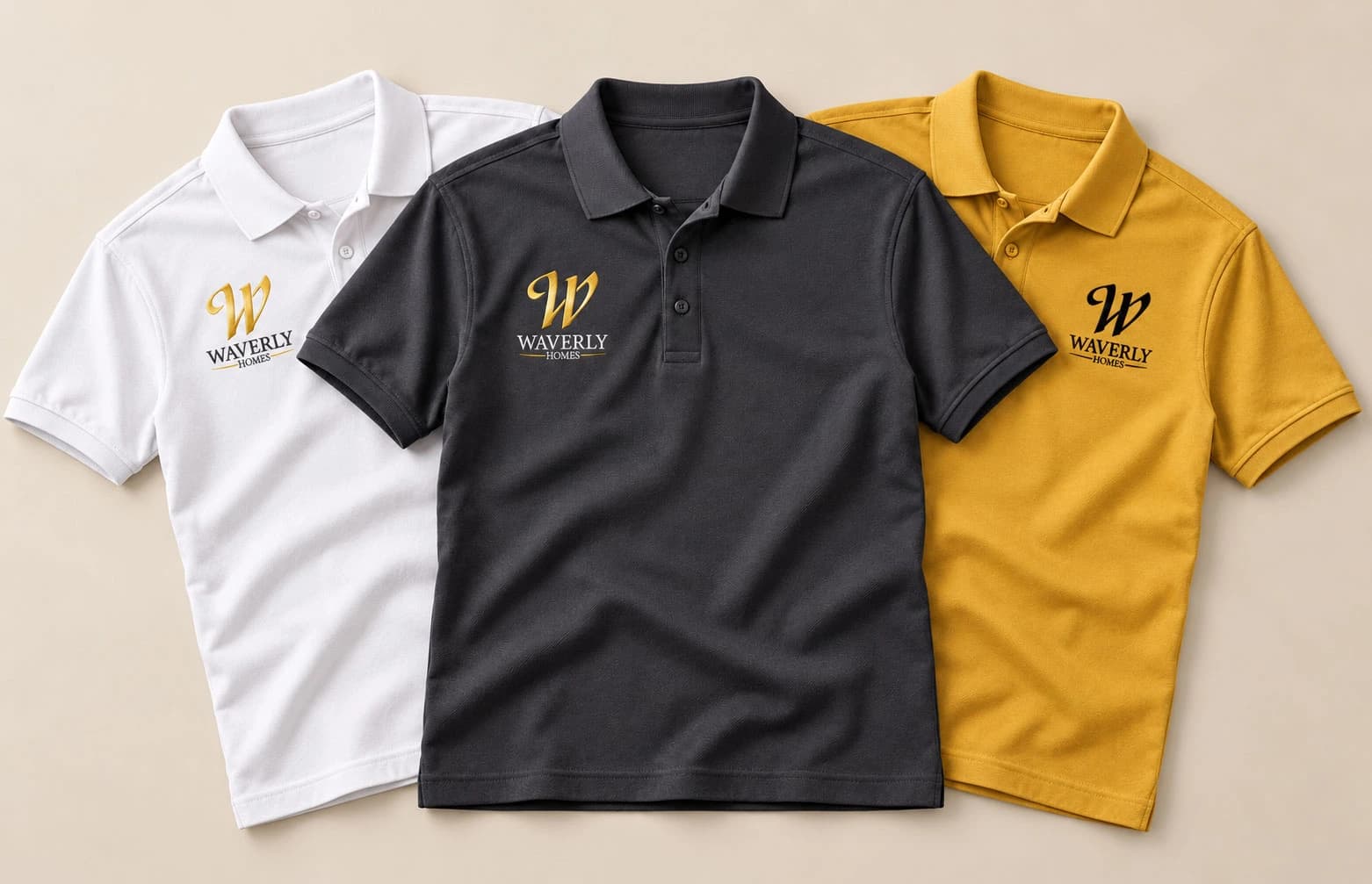 Charcoal, white and gold polo shirts featuring embroidered Waverly Homes logos